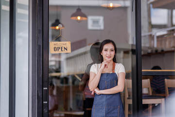 Asian store owner opening for business independent business, female barista, startup idea, SME business.