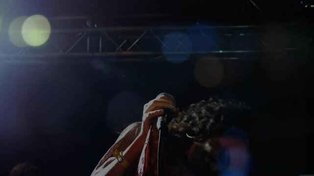 Singing into microphone, performer with dynamic lighting and lens flare animation