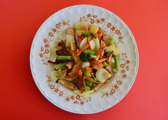 Asian stir fried vegetables featuring Shiitake mushrooms on a bed of long grain rice. 