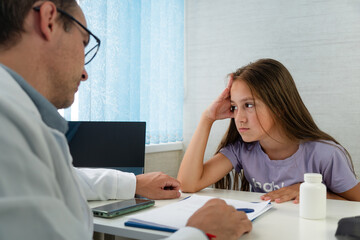 child at pediatrician appointment. Concentrated attentive therapist professional consulting client...