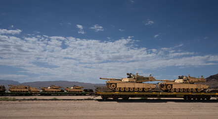 Military tanks on railroad car
