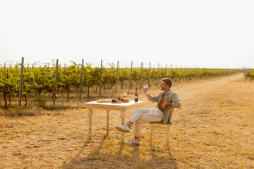 Relaxing afternoon in a vineyard with wine and fresh produce under the warm sun