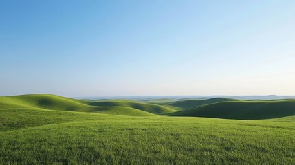 Obraz premium A scenic view of rolling green hills under a clear blue sky 