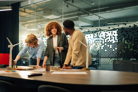 Interracial staff collaborating on sustainable and renewable energy.