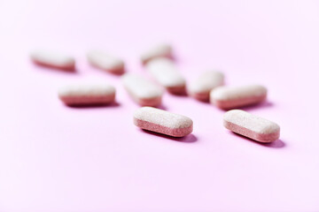 Ashwagandha (Withania somnifera) tablets. Concept for a healthy dietary supplementation. Bright paper background. Close up. Copy space.