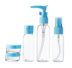 Clear plastic bottles with blue pumps and spray tops arranged on a white background