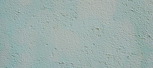 Obraz premium Rough textured background of an uneven pastel green concrete wall