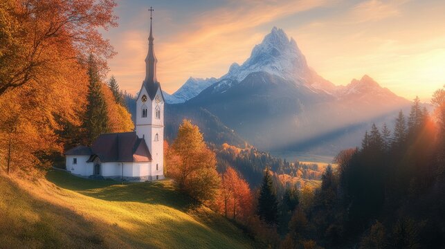 Sunrise over Maria Gern Church with Hochkalter Peak in the background, autumn colors in full display