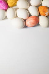 Easter eggs and pastel colored eggs on a white background
