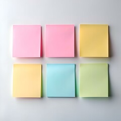 Fototapeta premium Six blank sticky notes in pastel colors pink. yellow. light blue and green arranged in a row on a white background.