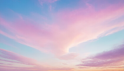 The sky is painted in soft shades of pink and blue as the sun sets, casting a serene glow over the horizon and reflecting on the clouds, creating a peaceful evening ambiance