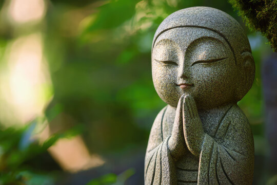 A Stone Guardian: Jizo, protector of children, stands serene, hands clasped in prayer, amidst a backdrop of soft, green foliage.