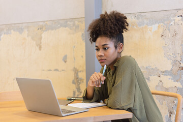 African American woman and working on laptop.