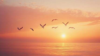 Fototapeta premium A flock of seagulls flying above the ocean at sunset, with the sky painted in orange and pink hues, leaving ample space in the upper sky for text.