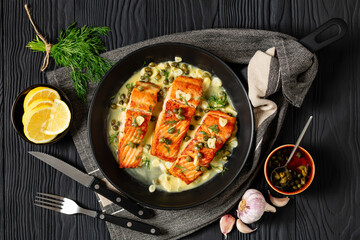 salmon piccata with lemon caper sauce in a pan