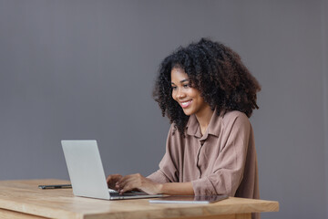 Excited African American woman with laptop. 