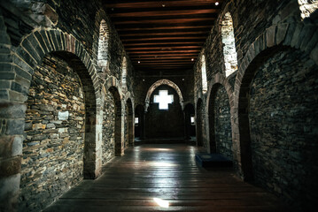 Cross Window in Medieval Stone Hallway