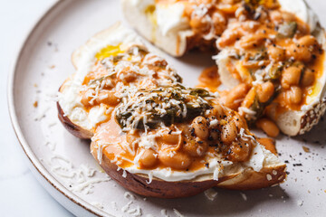 Bagel with cream cheese and bean stew.