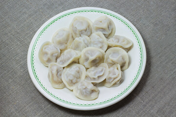Plate with dumplings and fork on the table