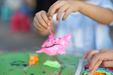 Mother and daughter doing colorful crafts in outdoor garden