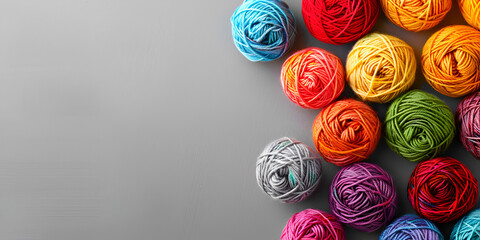  close-up of several colorful balls on a gray background. The balls are arranged in a row and are colored red, blue, green, yellow, and orange.