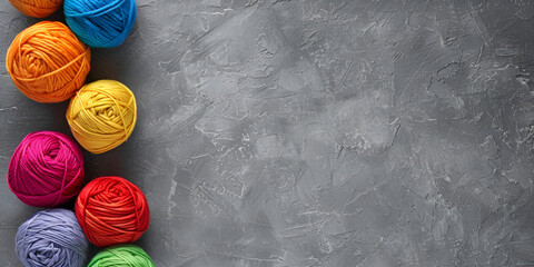  close-up of several colorful balls on a gray background. The balls are arranged in a row and are colored red, blue, green, yellow, and orange.