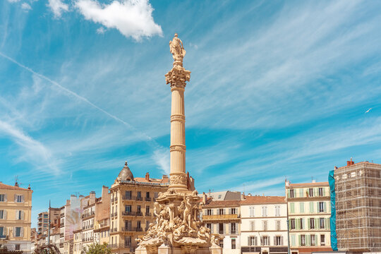 Place Castellane square with 1910s fountain featuring elaborate sculptures and a marble pillar, Marseille, France.