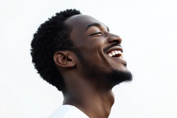 Obraz premium Close up profile portrait of handsome young black man laughing against isolated white background