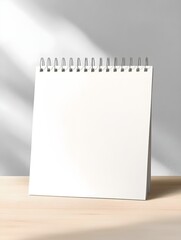 Blank paper desk spiral calendar mock-up. Minimal photography with copy space for your text. Empty 3d table calendar. Office and home decor. Bright minimalism background photography