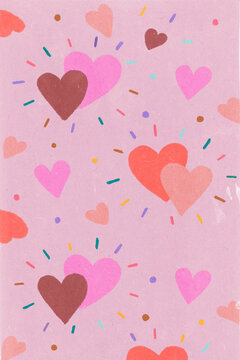 Cheerful and romantic design with colorful hearts floating on pink background