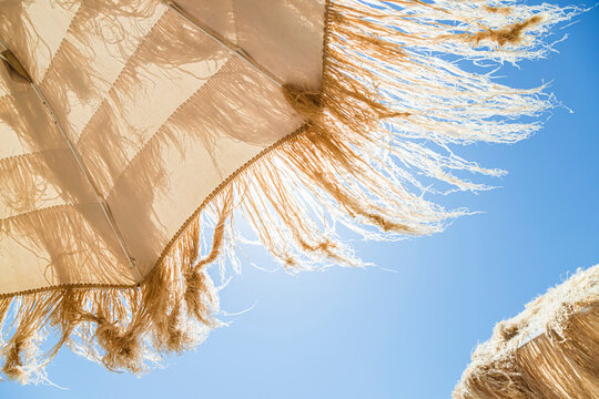 Thatched beach umbrella under blue sky
