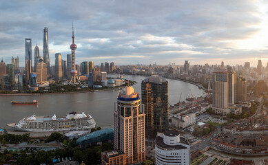 Aerial view of the Shanghai skyline with skyscrapers and the Huangpu River.