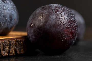 close-up of purple plum fruits in drops of water