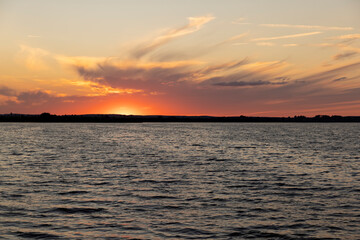 beautiful bright sunset on the lake in the summer