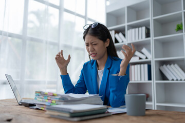businesswoman plans a finance audit, reviewing documents while battling burnout syndrome.