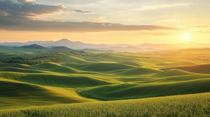 Obraz premium Golden Sunset Illuminating Rolling Green Hills in a Tranquil Landscape With Distant Mountains and a Serene Atmosphere