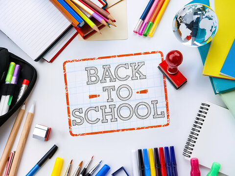 Colorful 'Back to School' Text on White Desk with Red Stamp and Details