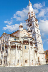 Fototapeta premium The stunning Cathedral of Modena and Torre Civica tower under a vibrant blue sky in Piazza Grande, Modena, Emilia-Romagna. Italy