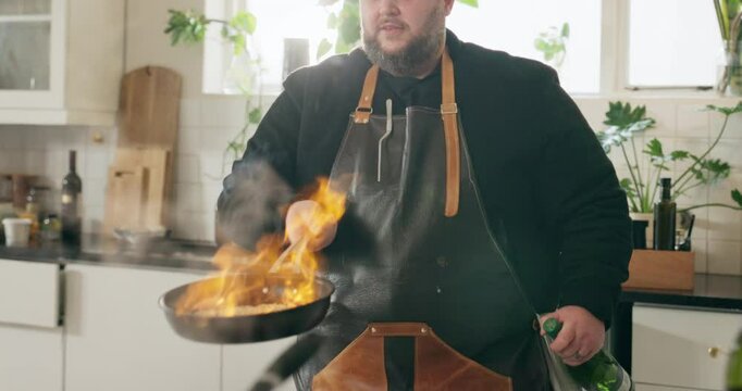 Man, flambe and kitchen as chef for nutrition, diet or hospitality in home with frying pan. Male person, culinary art for gourmet cuisine, cooking or technique for meal preparation, dinner and food