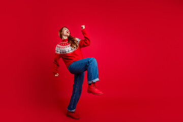 Fototapeta premium Photo of young positive energetic lady dancing wearing seasonal sweater and jeans clubbing isolated on red color background