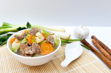 Beef soup, with carrots, potatoes and tomatoes.