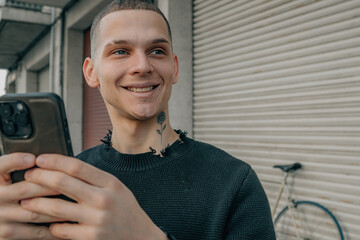 portrait young man on the street with smartphone or cell phone and bicycle