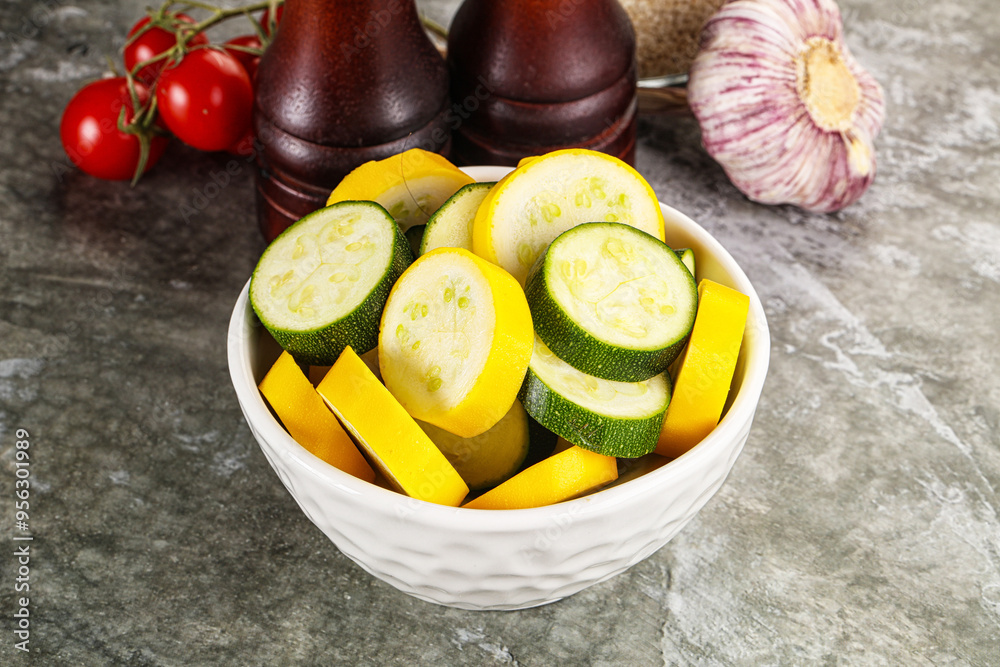 Wall mural sliced raw young green and yellow zucchini