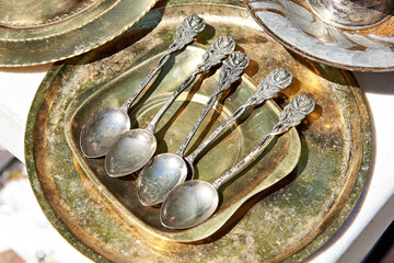 Antique silver and brass tableware at flea market