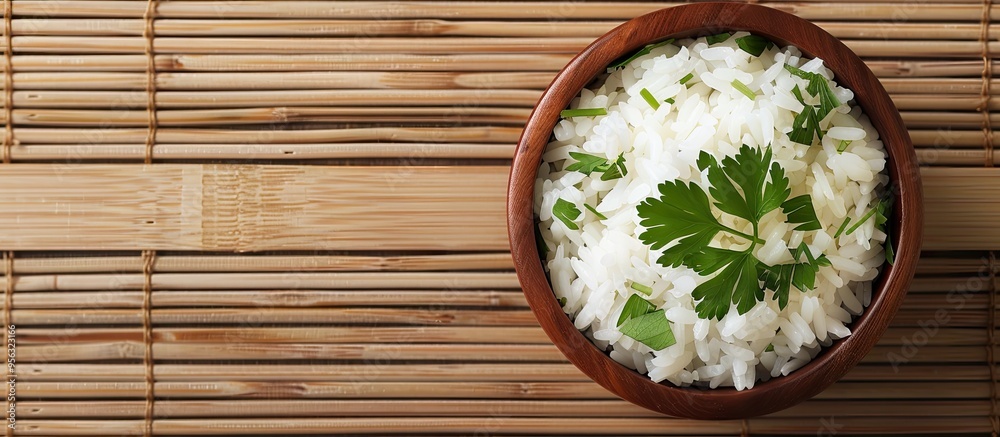 Leinwandbilder top view of appetizing boiled rice bowls garnished with parsley on a bamboo mat suitable for adding 