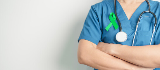 Doctor with green Ribbon for world Lymphoma Awareness September month, world Mental Health Day,...