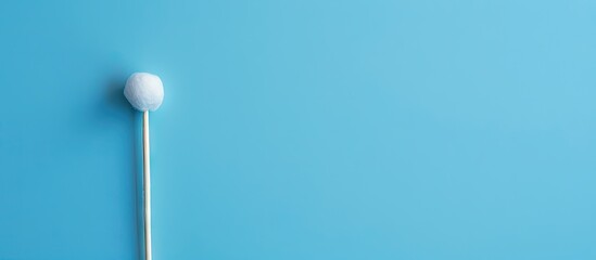 Plastic cotton bud on blue with copy space image