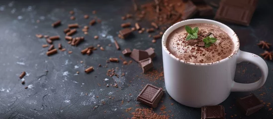 Selbstklebende Fototapeten Mug with tasty hot chocolate on a dark table with copy space image © HN Works