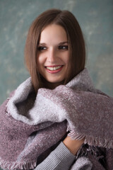 Cute young woman wrapped in a warm scarf