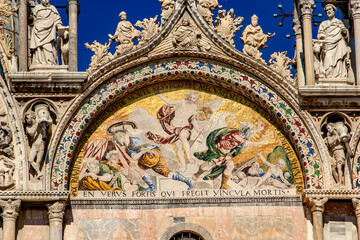 Fototapeta premium Basilica di San Marco or St Mark's Basilica, Venice, Italy. It is the main travel attraction of Venice. Luxury facade of St Mark's church close-up. Ornate detail of landmark of Venice in summer.